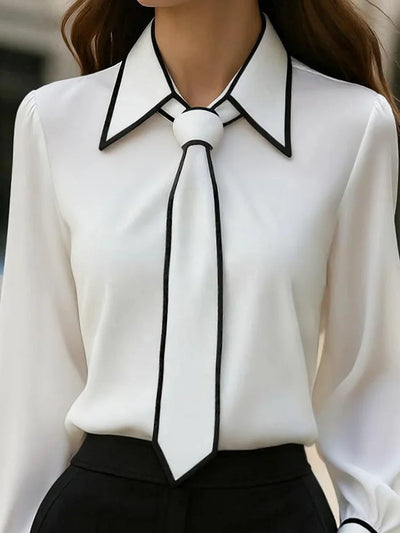Blusa elegante con cuello anudado y ribete en contraste