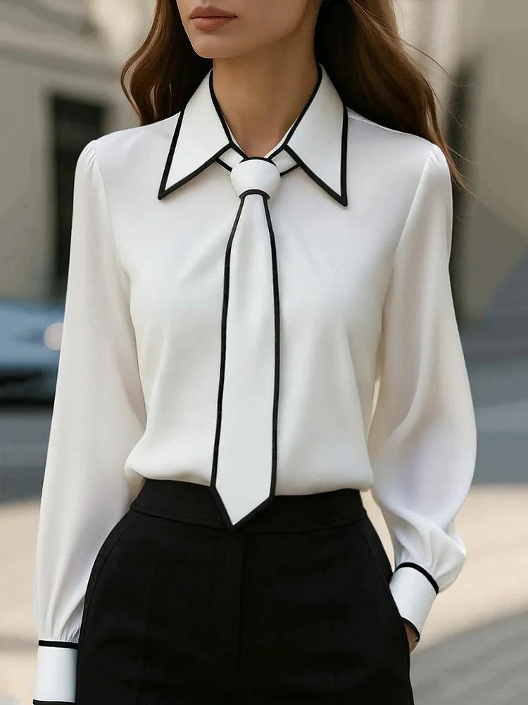 Blusa elegante con cuello anudado y ribete en contraste