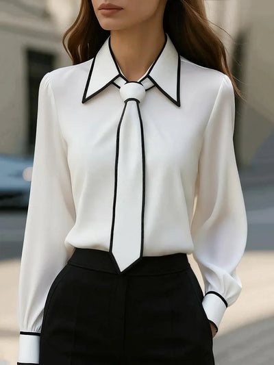Blusa elegante con cuello anudado y ribete en contraste